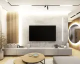 Nowoczesny salon z betonową ścianą, na której wisi telewizor. Obok pionowe lamele drewniane, a w tle okrągłe lustro z podświetleniem.